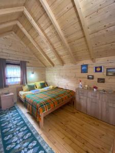 a bedroom with a bed in a wooden room at Tara Riverside in Mojkovac