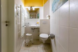 a small bathroom with a toilet and a sink at Muschel 4 in Ahrenshoop +17 photos