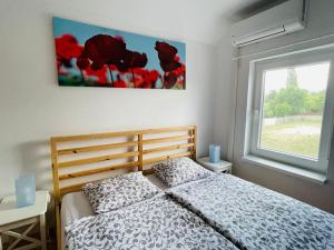 מיטה או מיטות בחדר ב-Dunakanyar Apartman
