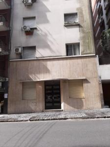 a building with two garage doors on the side of a street at DTO 1AMB. RECOLETA in Buenos Aires +4 photos