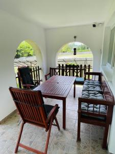 a living room with a wooden table and chairs at Dunakanyar Apartman in Pilismarót