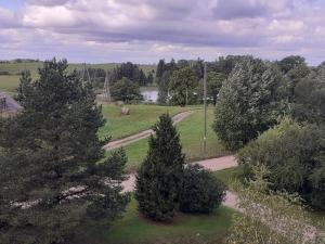 an aerial view of a park with trees and a road at Viesu nams Vizbulītes in Talsi