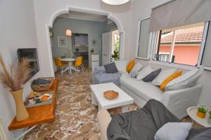 a living room with a couch and a table at Yia Sou Corfu! "Kolibri" in Sinarádes