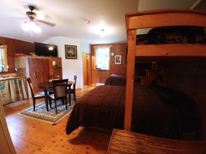 a bedroom with a bed and a table and a dining room at Bone Creek Wilderness Retreat in Blue River