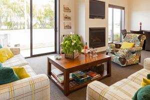 a living room with two couches and a coffee table at Hawkdun Lodge in Ranfurly