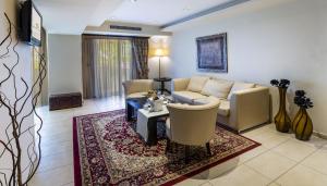 a living room with a couch and a table at Amalias Hotel in Kourouta