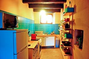 a kitchen with a refrigerator and a sink in it at Ruine-Motovun KH in Motovun