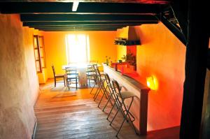 a room with a bar with chairs and a table at Ruine-Motovun KH in Motovun
