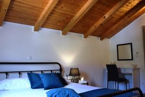 a bedroom with a bed and a desk and wooden ceilings at Villa Marta's - Marta I in Trogir