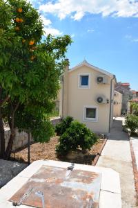 an orange tree in front of a house at Villa Marta's - Marta I in Trogir