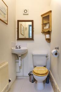 a bathroom with a toilet and a sink at Bramble Cottage in Whiteparish