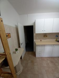 una cocina con armarios blancos y una escalera en una habitación en Sweet House en Lisboa