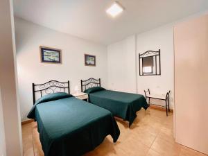 מיטה או מיטות בחדר ב-Casa Josefa 2