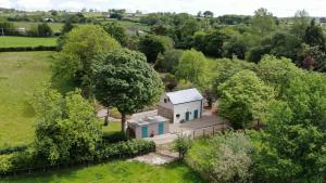 an aerial view of a white house in a field at Blackshaw's Studio in Scolboa
