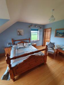 a bedroom with a wooden bed and a window at Wild Atlantic Stays in Castlemaine