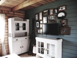 a room with a tv and a white cabinet at Chalet Lily in Žabljak