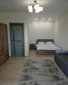 a bedroom with a bed and a door with a rug at Квартира в новобудові in Luts'k