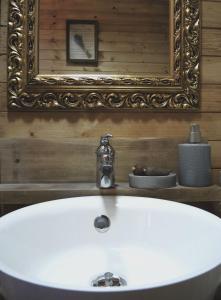 a white sink in a bathroom with a mirror at Chalet Lily in Žabljak +55 photos