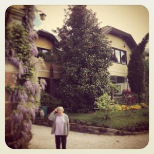 Eine Frau, die vor einem Haus steht. in der Unterkunft Haus Marianne in Millstatt