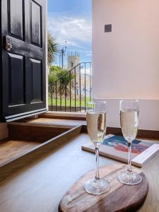 two glasses of white wine sitting on a table at 14-16 Grosvenor Street Luxury Apartments - Chester in Chester