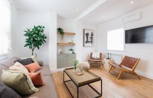 a living room with a couch and a table at 14-16 Grosvenor Street Stylish Apartments - Chester in Chester