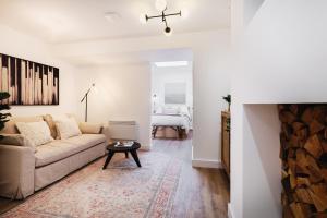 a living room with a couch and a table at 14-16 Grosvenor Street Stylish Apartments - Chester in Chester