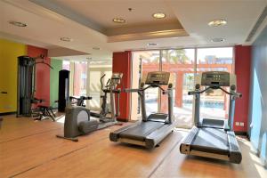 a gym with several tread machines in a room at Baylasun Icon in King Abdullah Economic City