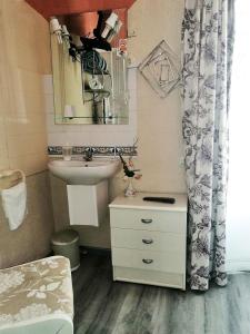 a small bathroom with a sink and a mirror at Hospedaje Botin in Santander