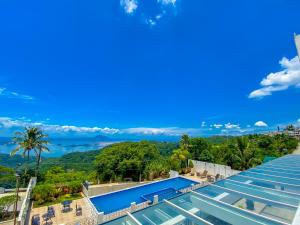 a swimming pool with a view of the mountains at Tagaytay Hotel SixB in Tagaytay