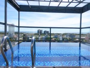 a swimming pool with a view of a city at The Shine Hotel & Apartment in Danang