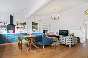 a living room with a table and a dining room at Blue House Bendigo in Bendigo