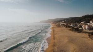 a view of a beach with houses and the ocean at Casa Costa Suites in Kanali