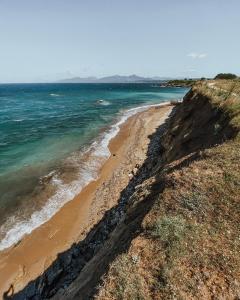 a view of a beach from a cliff at Casa Costa Suites in Kanali