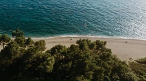 an aerial view of a beach with people in the water at Casa Costa Suites in Kanali