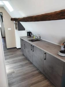a kitchen with a sink and a wooden floor at Das Herzchen von Cochem in Cochem