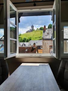 an open window with a view of a castle at Das Herzchen von Cochem in Cochem +28 photos