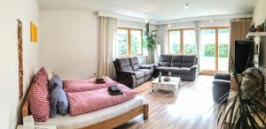 a living room with a bed and a couch at Oberachen Apartment in Ellmau
