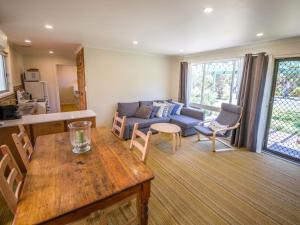 a living room with a couch and a table at 17 Broadbeach Drive in Normanville