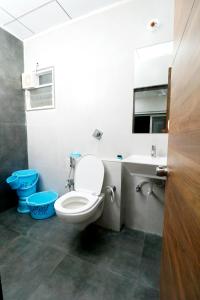 a bathroom with a toilet and a sink at Nova Sahaj Residency in Khirasra