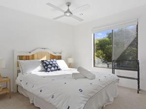 a white bedroom with a large bed and a window at 13 Scenic View Drive in Second Valley