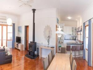 a living room with a fireplace and a stove at 3 Banksia Court in Normanville
