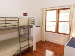 a room with two bunk beds and a window at 3 Banksia Court in Normanville