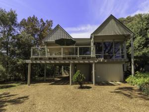 a large house with a large deck on top of it at Tranquillity on Riverview 33 Riverview Drive in Normanville