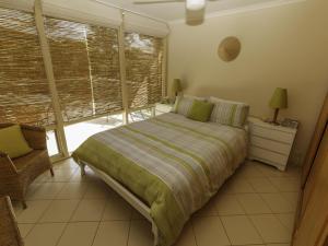 a bedroom with a bed and a large window at Tranquillity on Riverview 33 Riverview Drive in Normanville