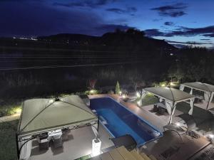 a swimming pool with two umbrellas next to at Acktion Deluxe in Shumen