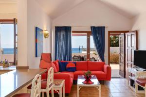 a living room with a red couch and a view of the ocean at Casa Maresia in Playa Honda