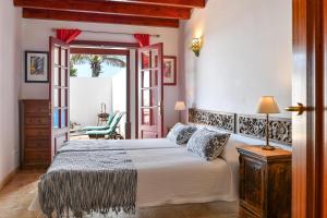 a bedroom with a bed and a table and a chair at Casa Maresia in Playa Honda +19 photos