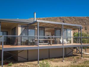 a house with a large deck with glass at 20 Lady Bay Road in Normanville