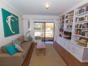 a living room with a couch and a tv at 20 Lady Bay Road in Normanville