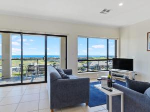 a living room with two couches and a tv at 18 Turnberry Drive in Normanville